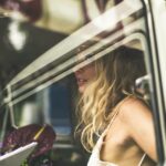 Bride inside wedding car showing reflection in the glass